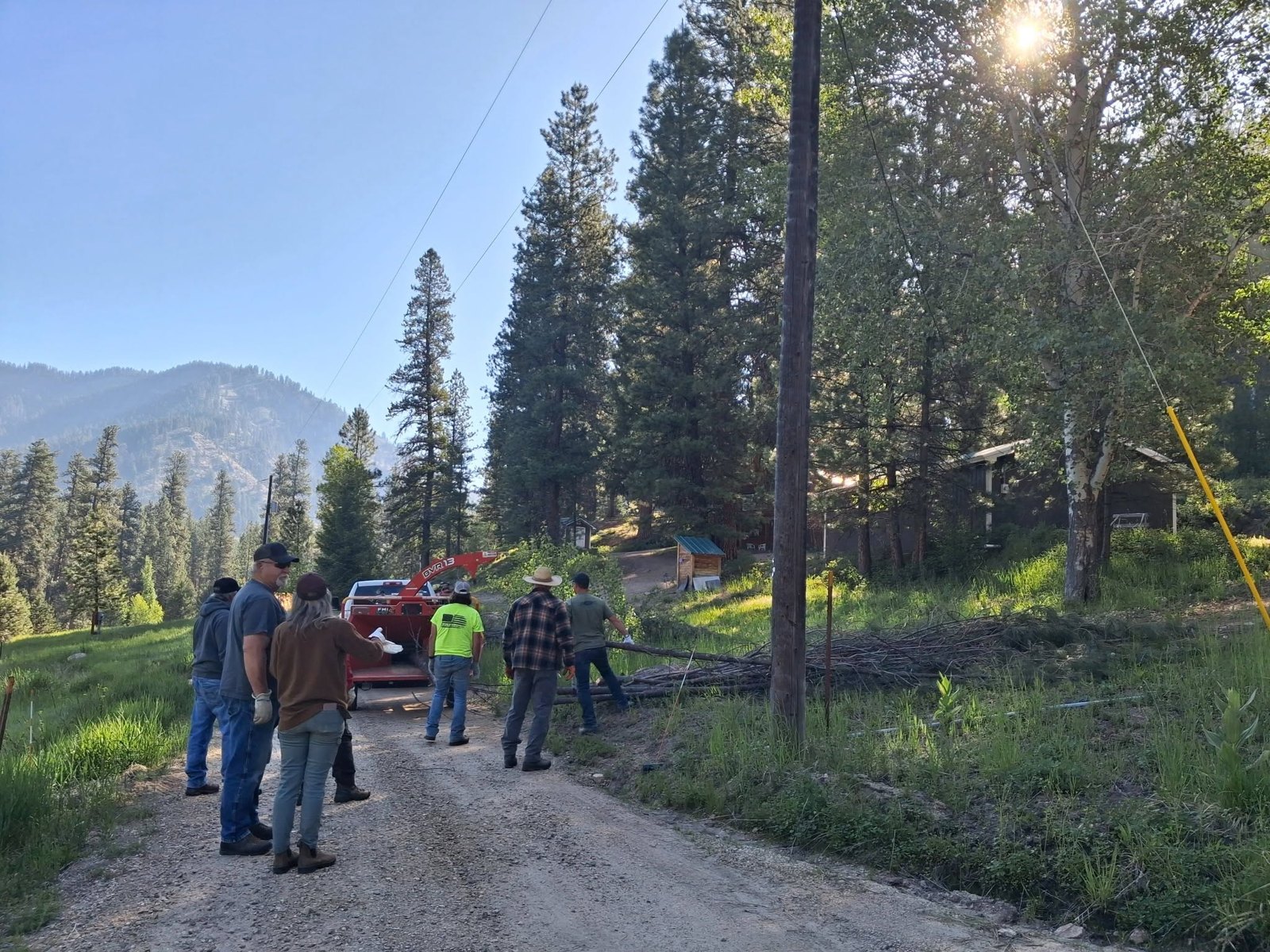 A crew gathers along the road.