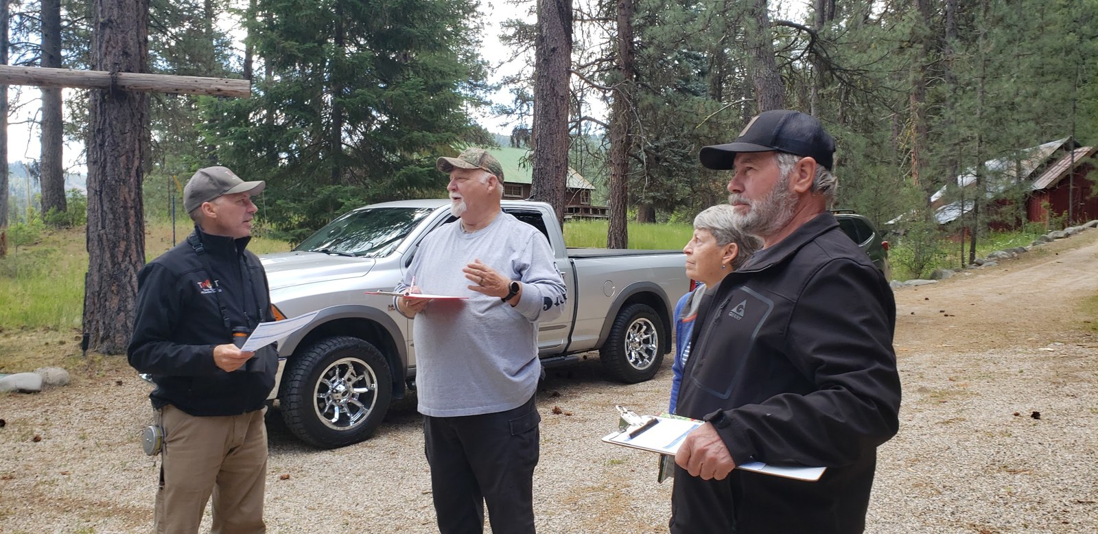 Neighbors and an assessor working through a Home Wildfire Risk Assessment on a Lowman property